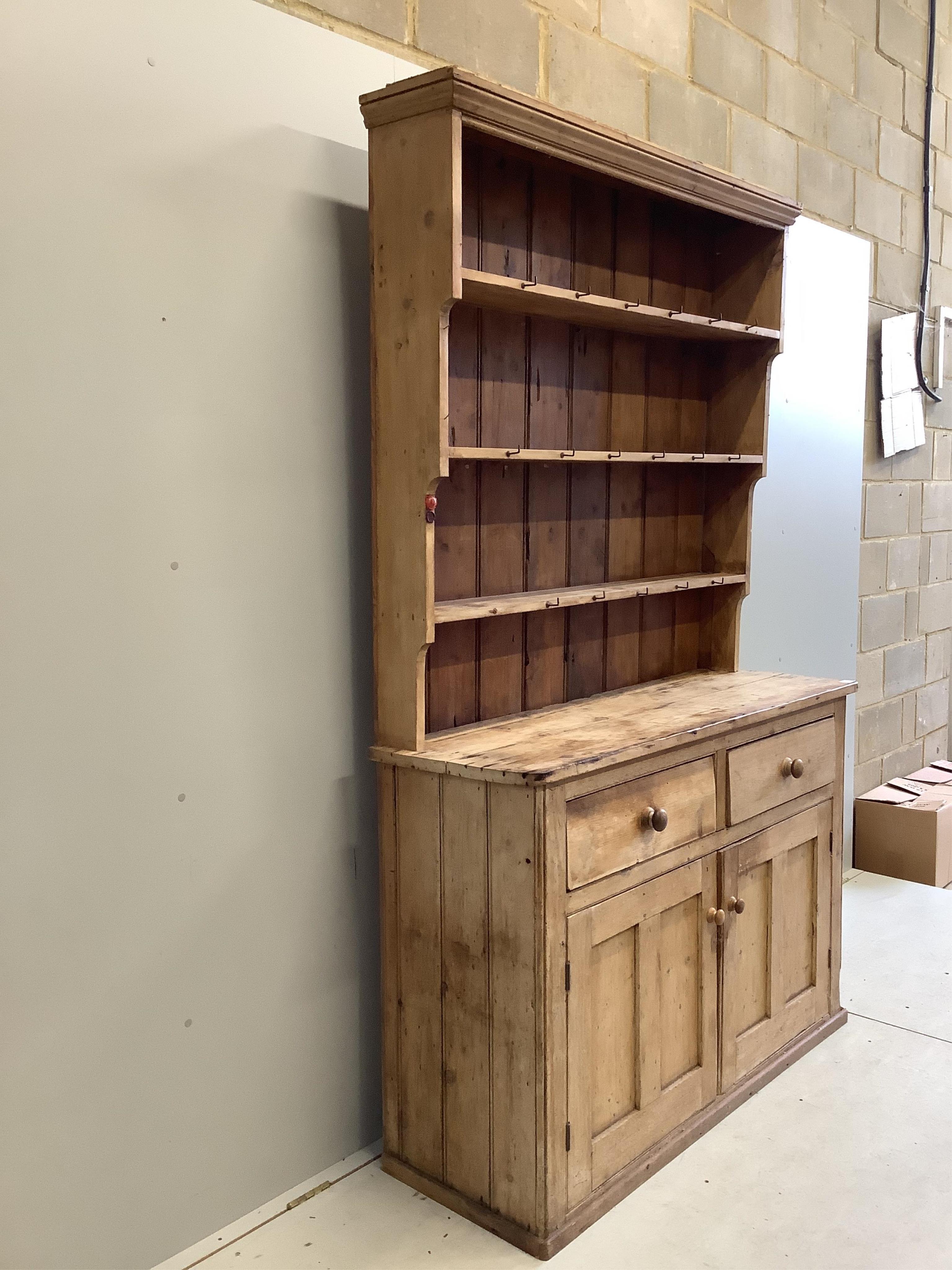 A Victorian pine dresser with boarded rack, width 140cm, depth 46cm, height 122cm. Condition - poor